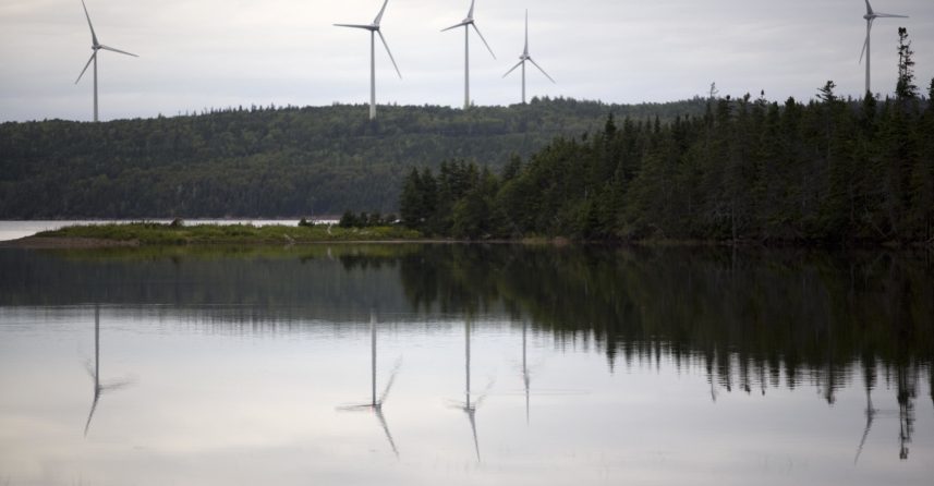 Windfarm with a body of water in front